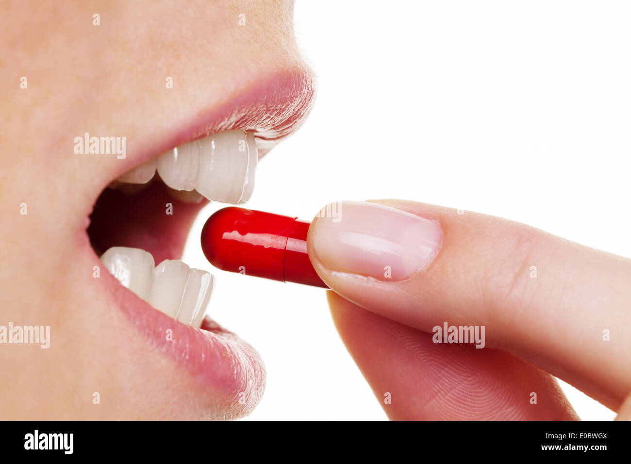 A woman takes the capsule of a tablet. Medical care drugs, Eine Frau nimmt die Kapsel einer Tablette ein. Medizinische Versorgun Stock Photo
