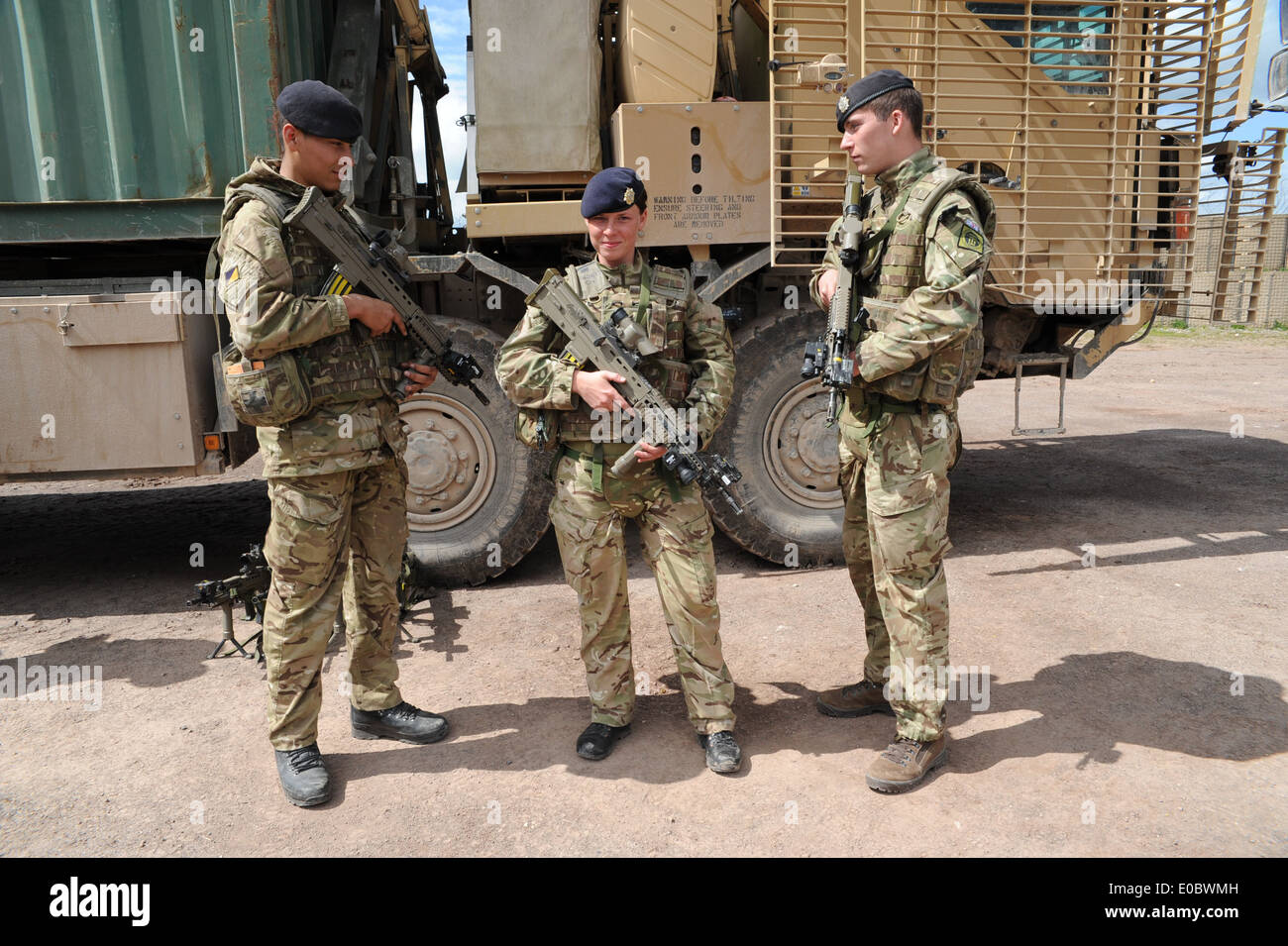 emale driver and two male comrades infont of there truck during a training exercise before they go to Afghanistan Stock Photo