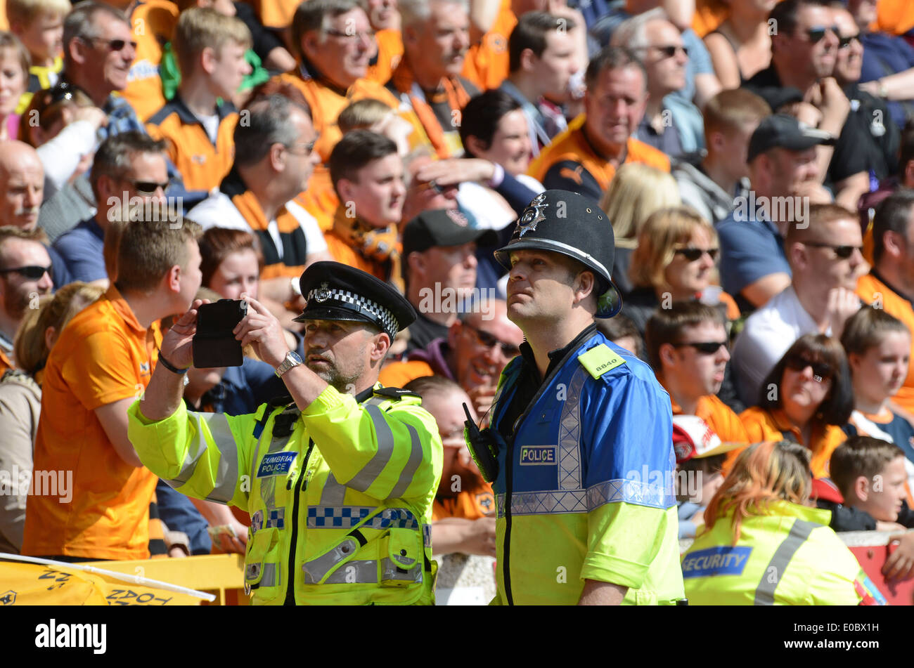Police officer officers policing football match Uk Stock Photo