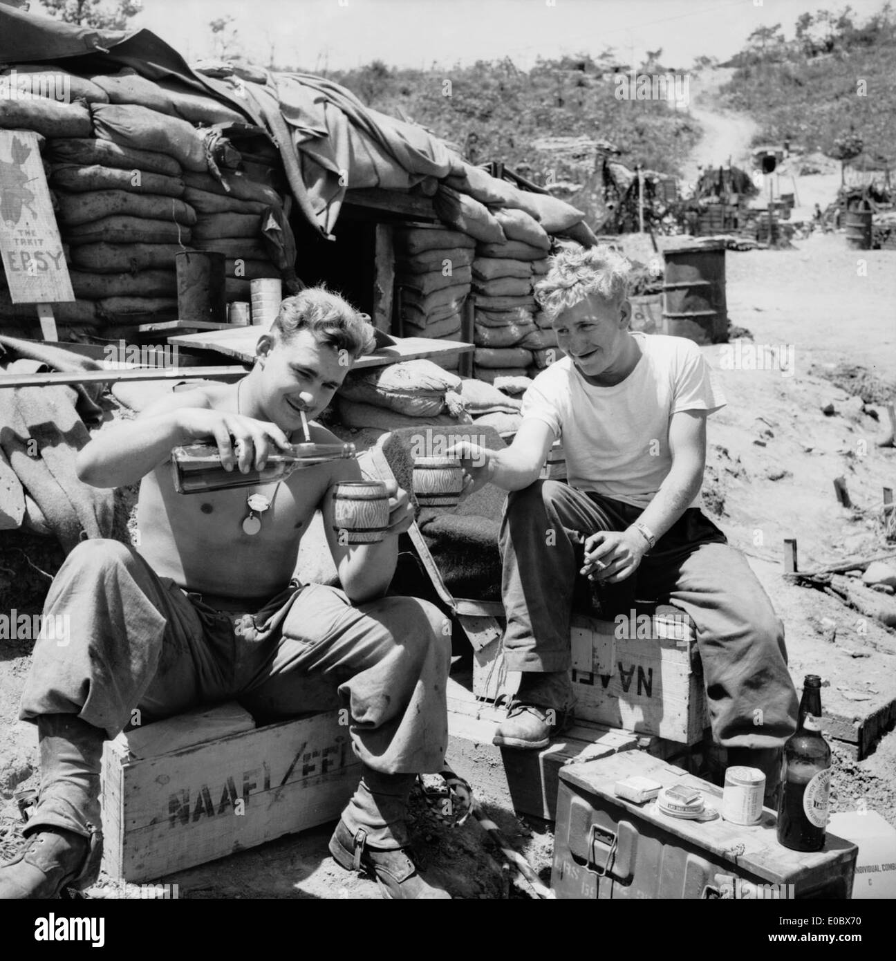 Two unidentified soldiers enjoy some recreation time at a sandbagged Navy Army Air Force Institute (NAAFI) Stock Photo