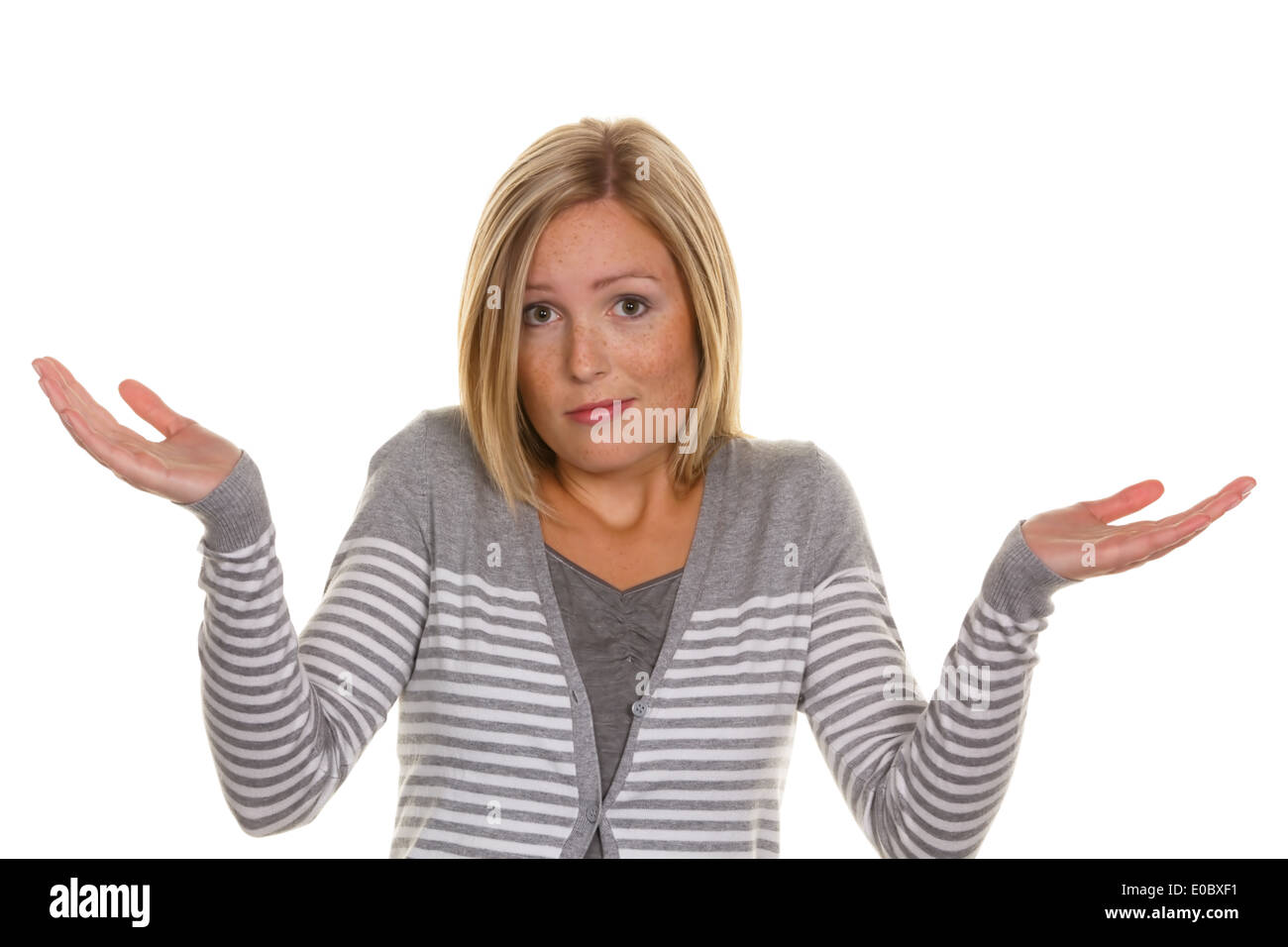 An unsuspecting woman twitches with the shoulders. Shrug and helplessness Stock Photo