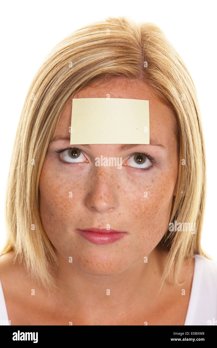 A young woman with a memorandum on the forehead, Eine junge Frau mit einem Merkzettel auf der Stirn Stock Photo