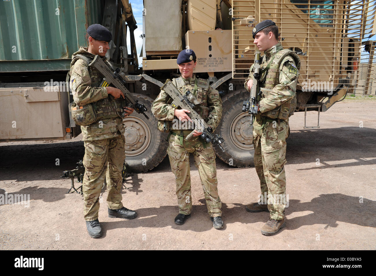 emale driver and two male comrades infont of there truck during a training exercise before they go to Afghanistan Stock Photo