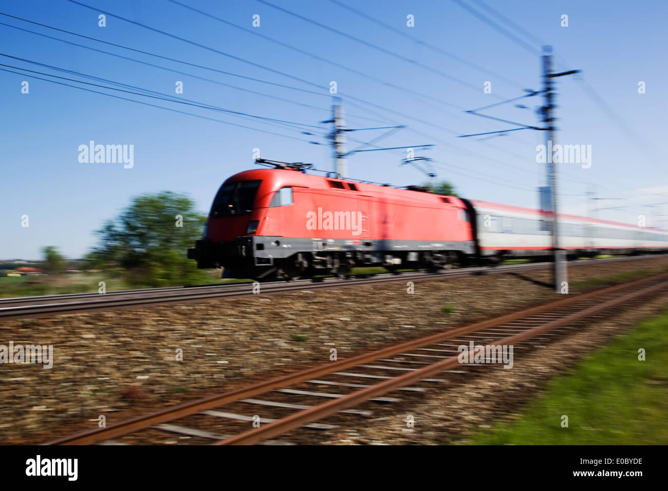 A train for people goes on railroad tracks, Ein Zug fuer Personen faehrt auf Eisenbahnschienen Stock Photo
