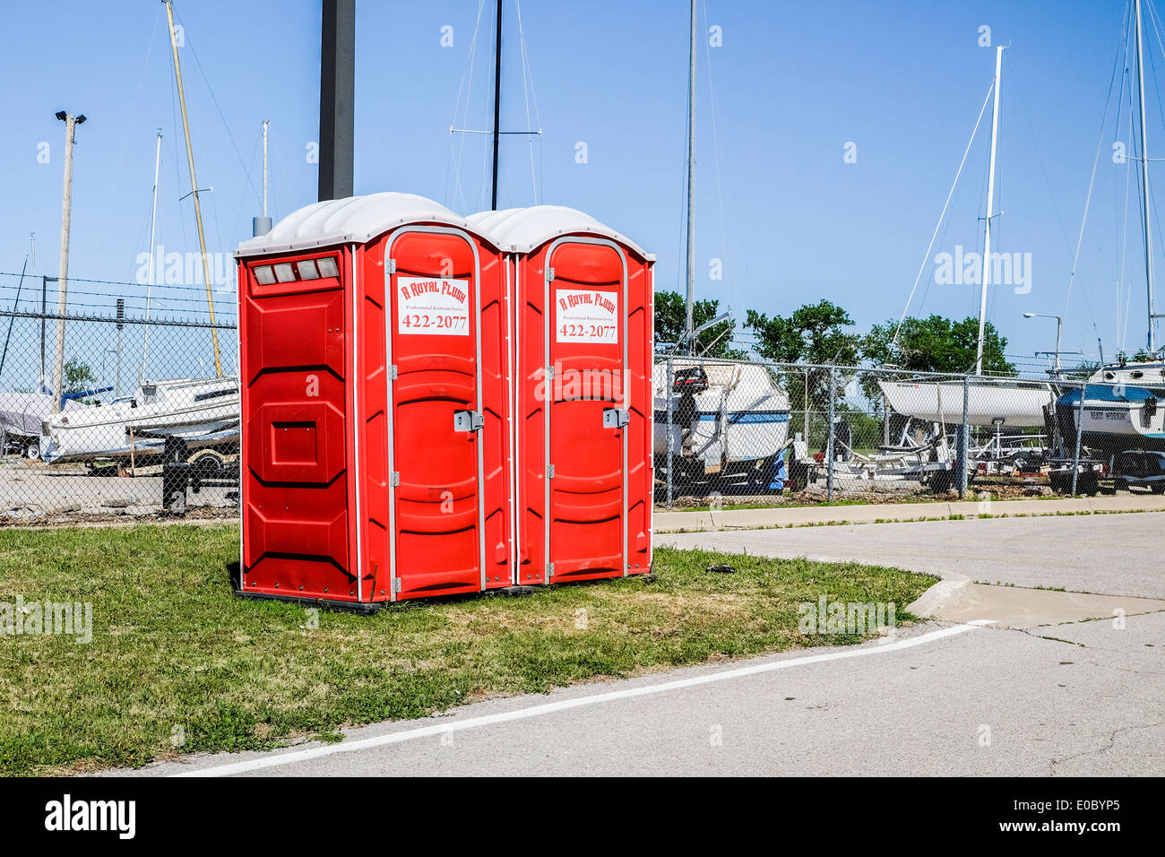 port-a-potties outside the fence of a boatyard in Oklahoma City, Oklahoma, USA. Stock Photo
