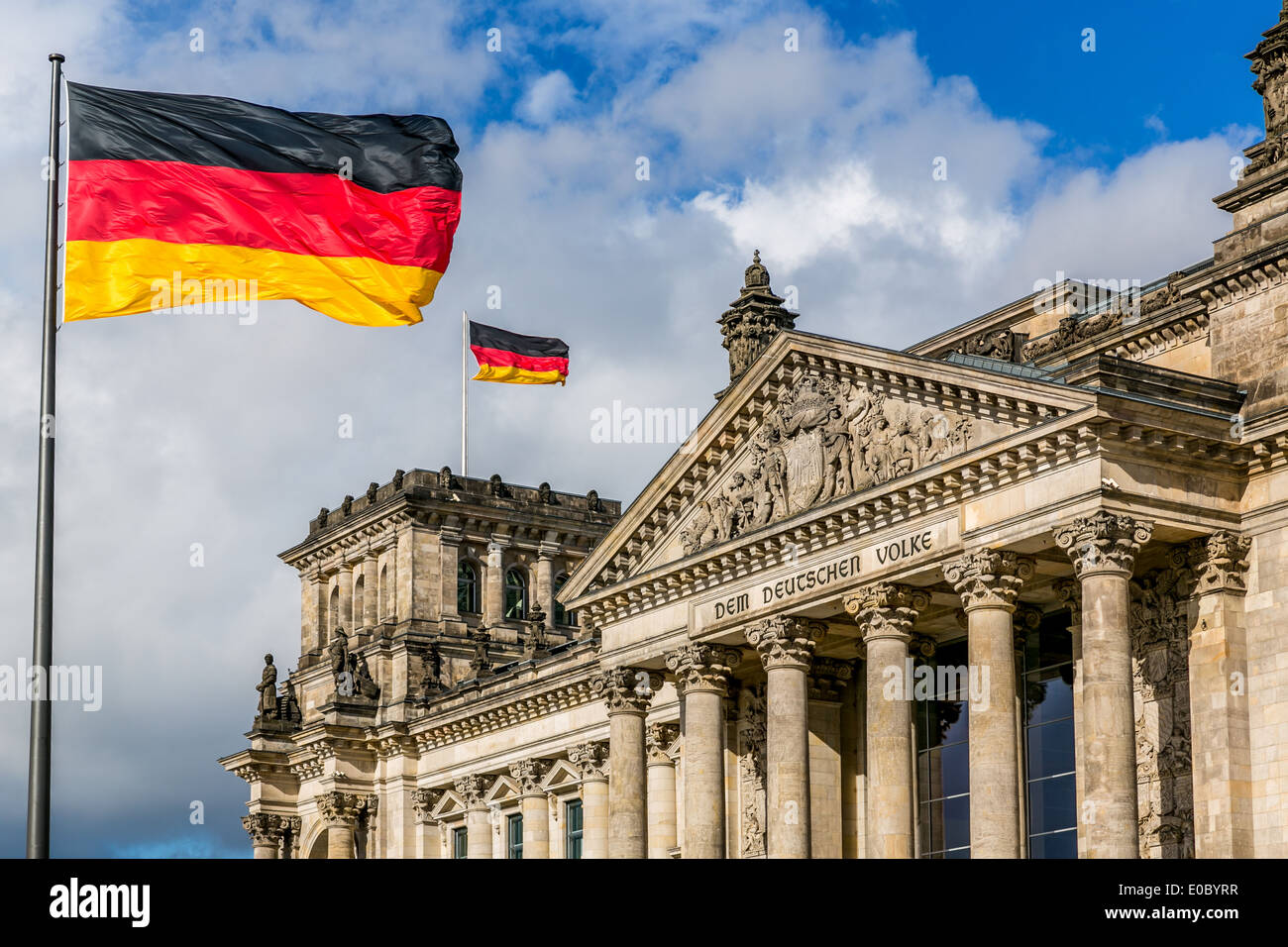 The Reichstag building with German flags, Berlin, Germany Stock Photo