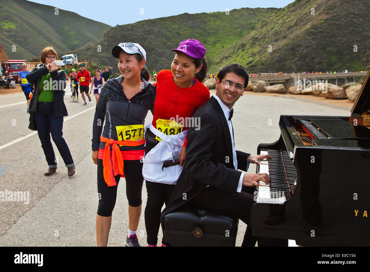 A concert pianist entertains the crowd near Bixby Bridge during the 2014 Big Sur Marathon - BIG SUR, CALIFORNIA Stock Photo