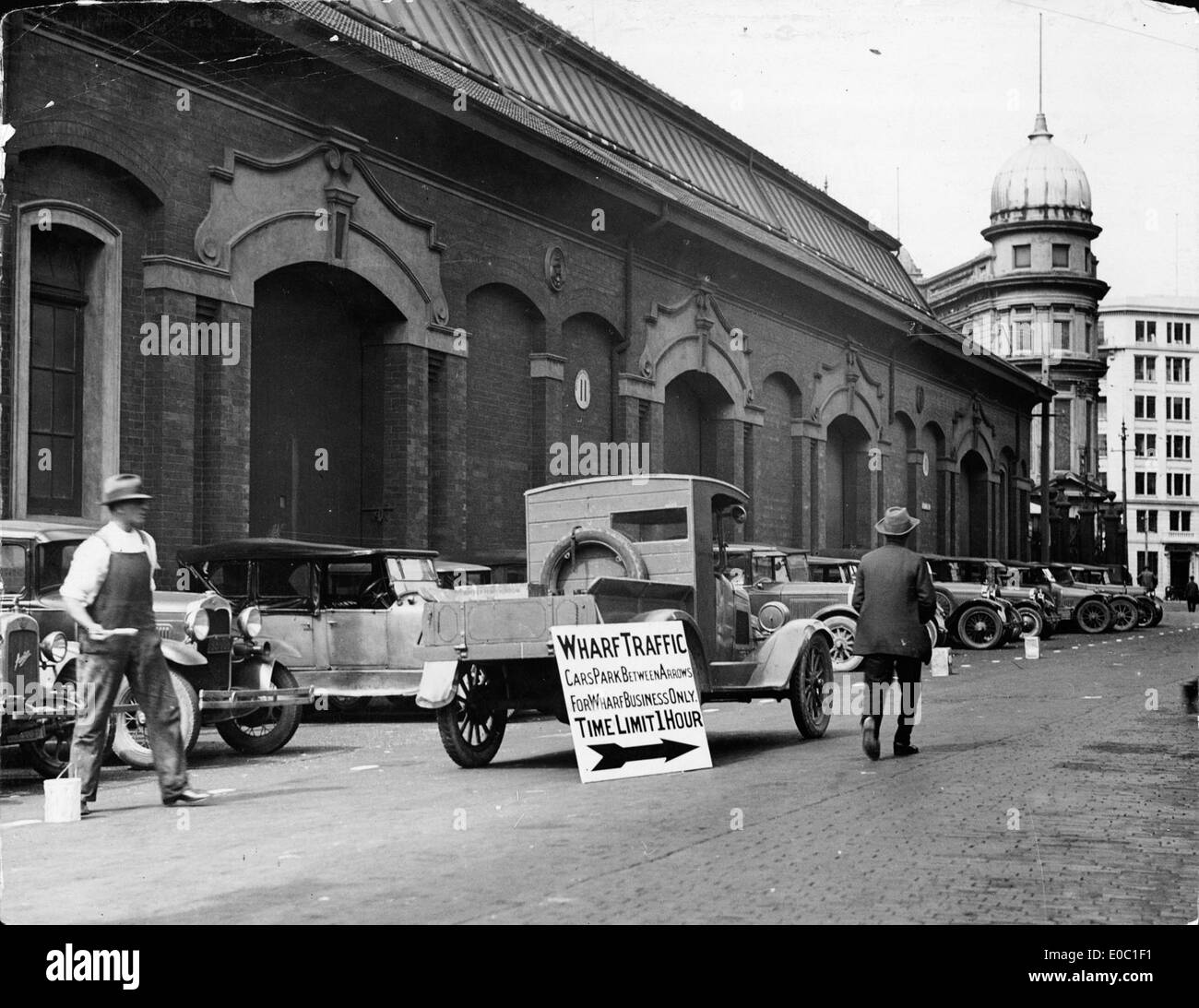 This photograph shows cars parked outside the Harbour Board's shed 11 in Wellington, New Zealand, on 3 March 1932, capturing the urban scene and transport at that time. Stock Photo