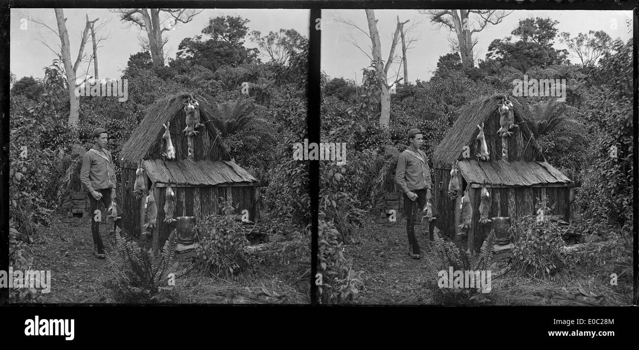 Edgar Williams standing beside a small hut, Pounawea, Catlins River, January 1906 Stock Photo