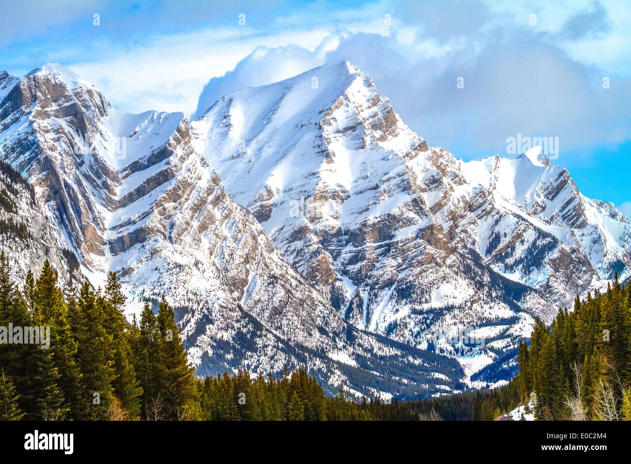 Snow covered, rugged, majestic  looking peak of Mt. Kidd, against blue sky. Kananaskis Provincial Park,  Alberta, Canada Stock Photo