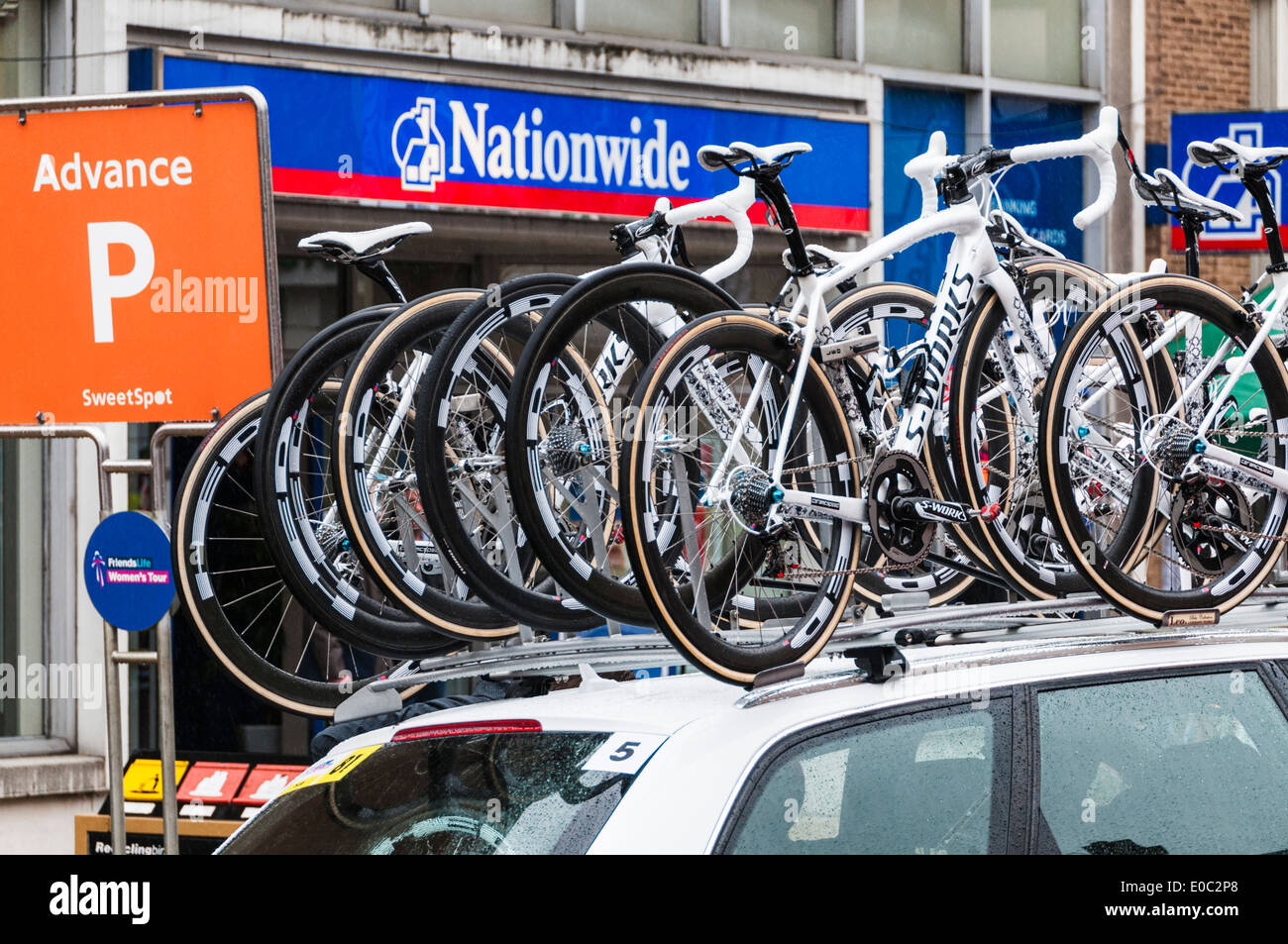 A Specialized Lululemon Team support vehicle loaded with spare bikes awaiting the start of the