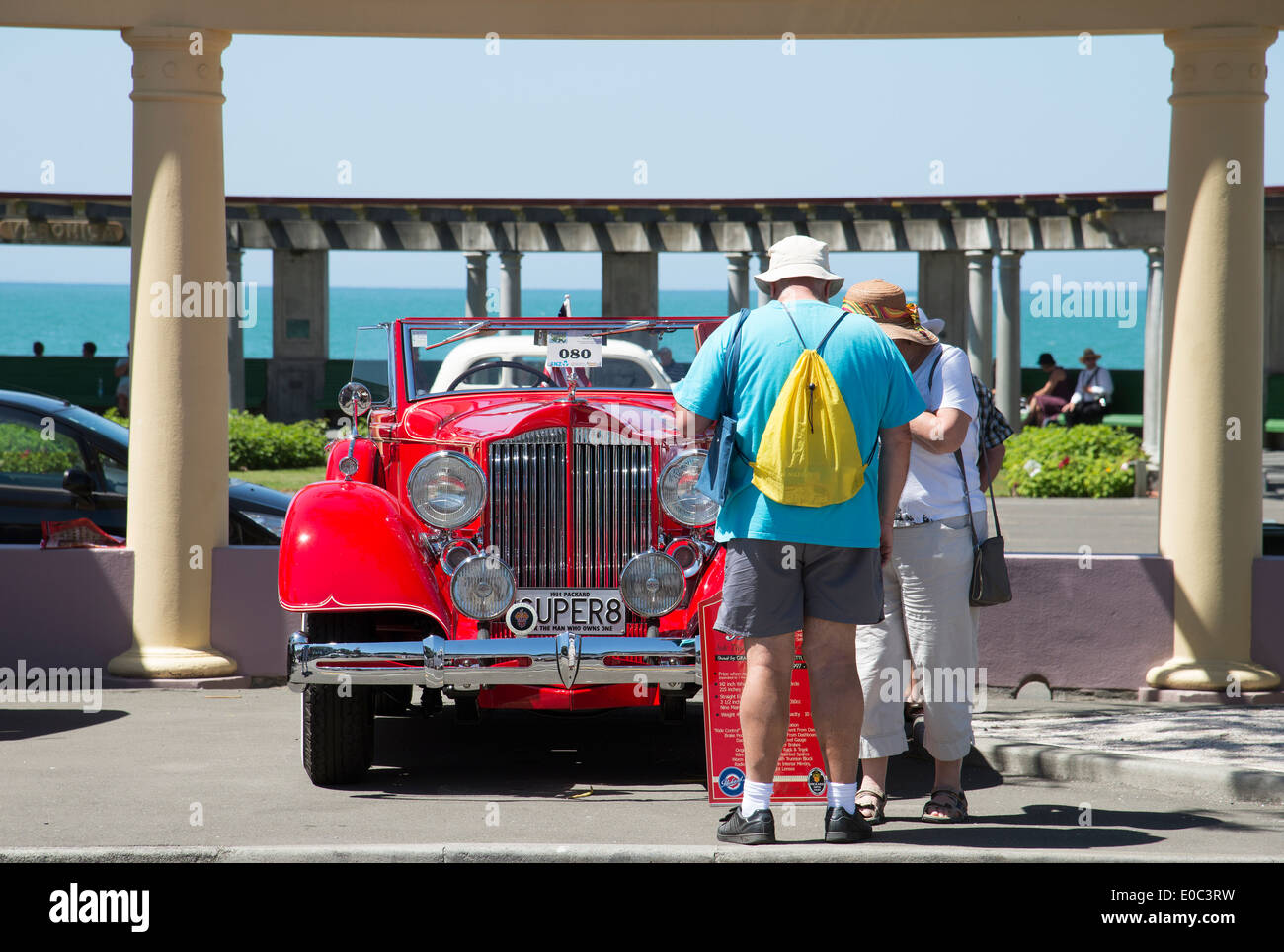 Art Deco weekend in Napier New Zealand A red Packard Super 8 classic car and tourists viewing Stock Photo