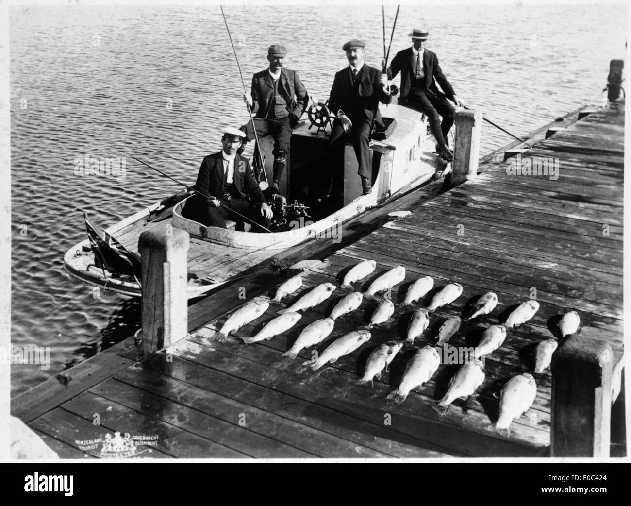 Group of anglers after a fishing trip on Lake Rotorua, ca 1903 Stock Photo
