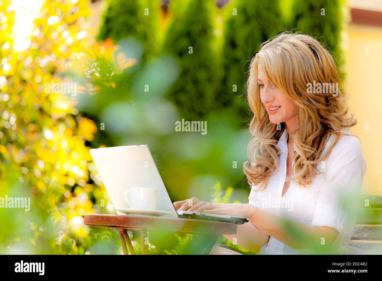 Young Woman Works With Laptop In The Garden Stock Photos Young