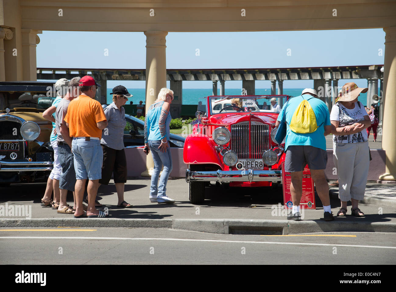Art Deco weekend in Napier New Zealand A red Packard Super 8 classic car and tourists viewing Stock Photo