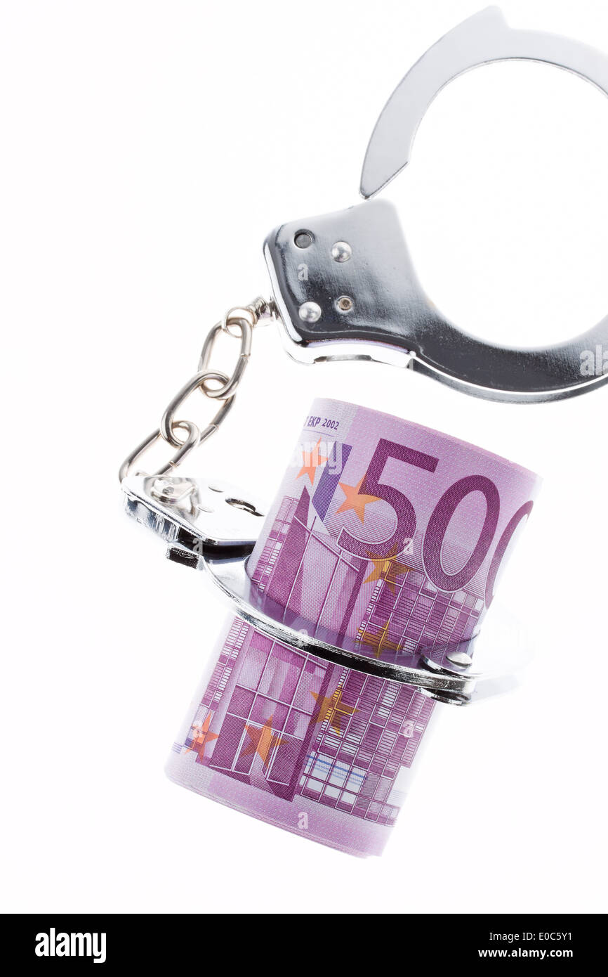 Symbol for economic criminal activity. handcuffs and euro, Symbol fuer Wirtschaftskriminalitaet. handschellen und Euro Stock Photo