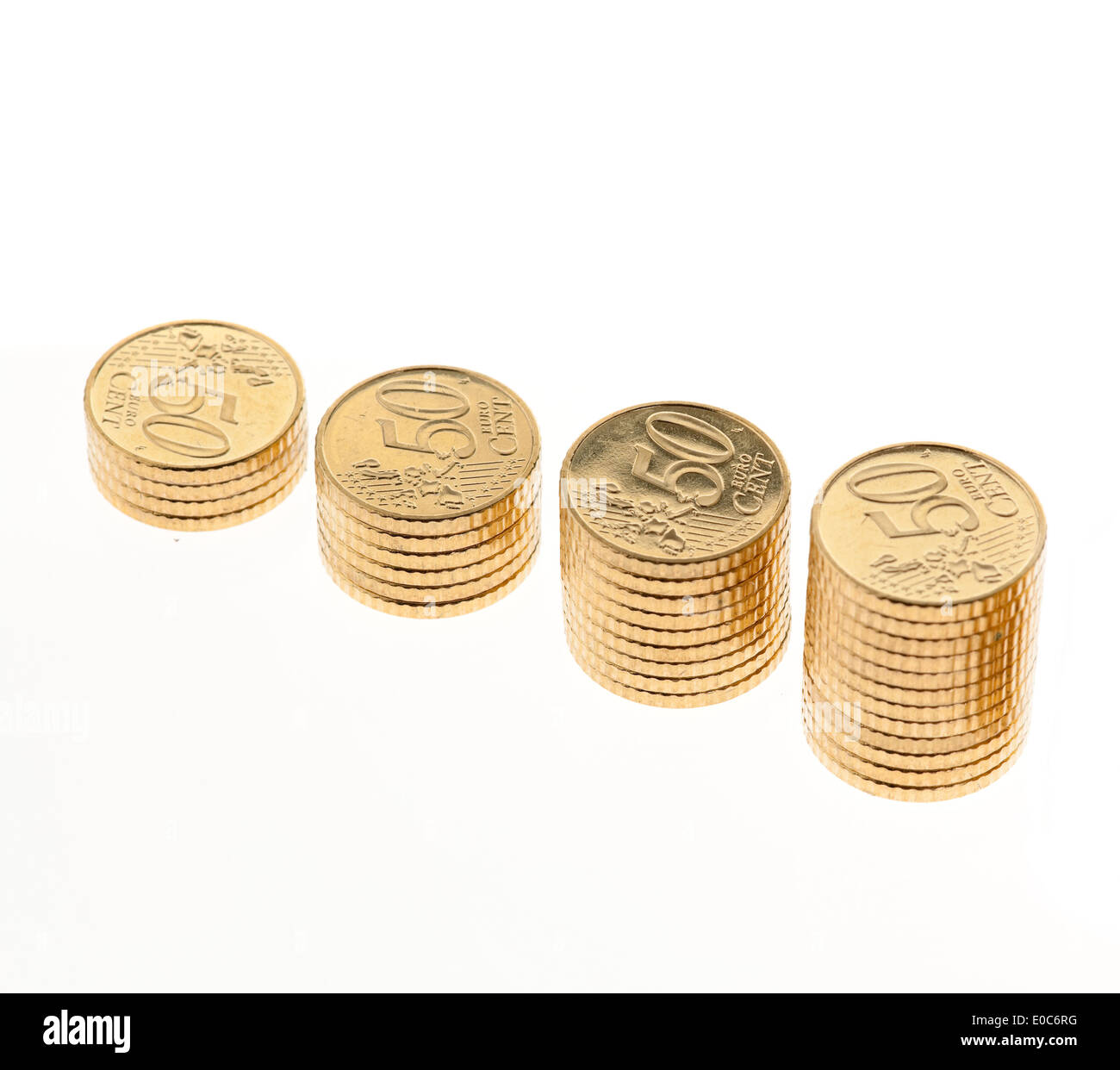 Some piles of euro of money coins on white background, Einige Stapel von Euro Geld Muenzen auf weissem Hintergrund Stock Photo