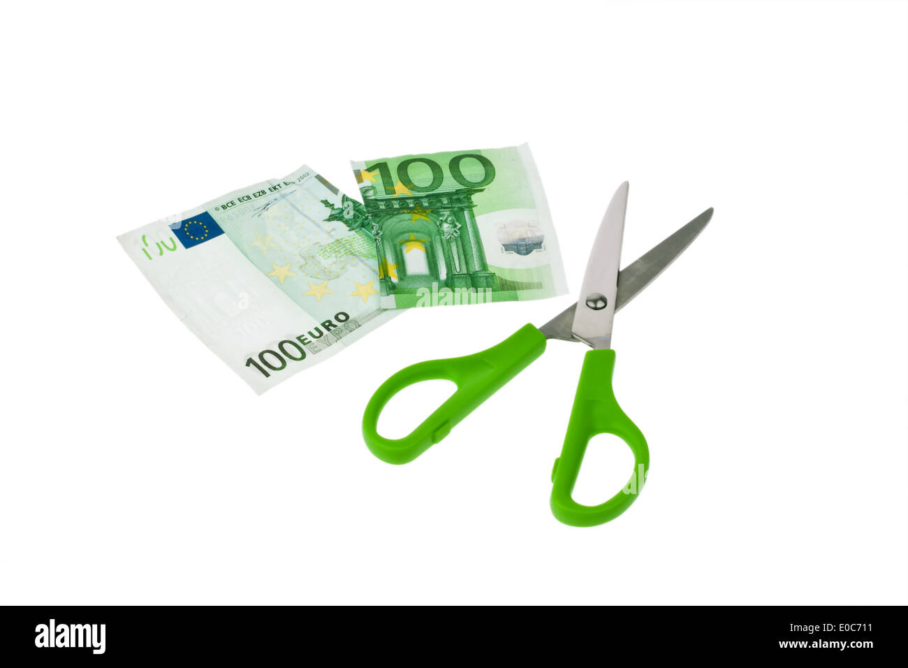 From a euro of bank note a piece is cut off with scissors. Symbol taxes and deliveries., Von einem Euro Geldschein wird mit eine Stock Photo