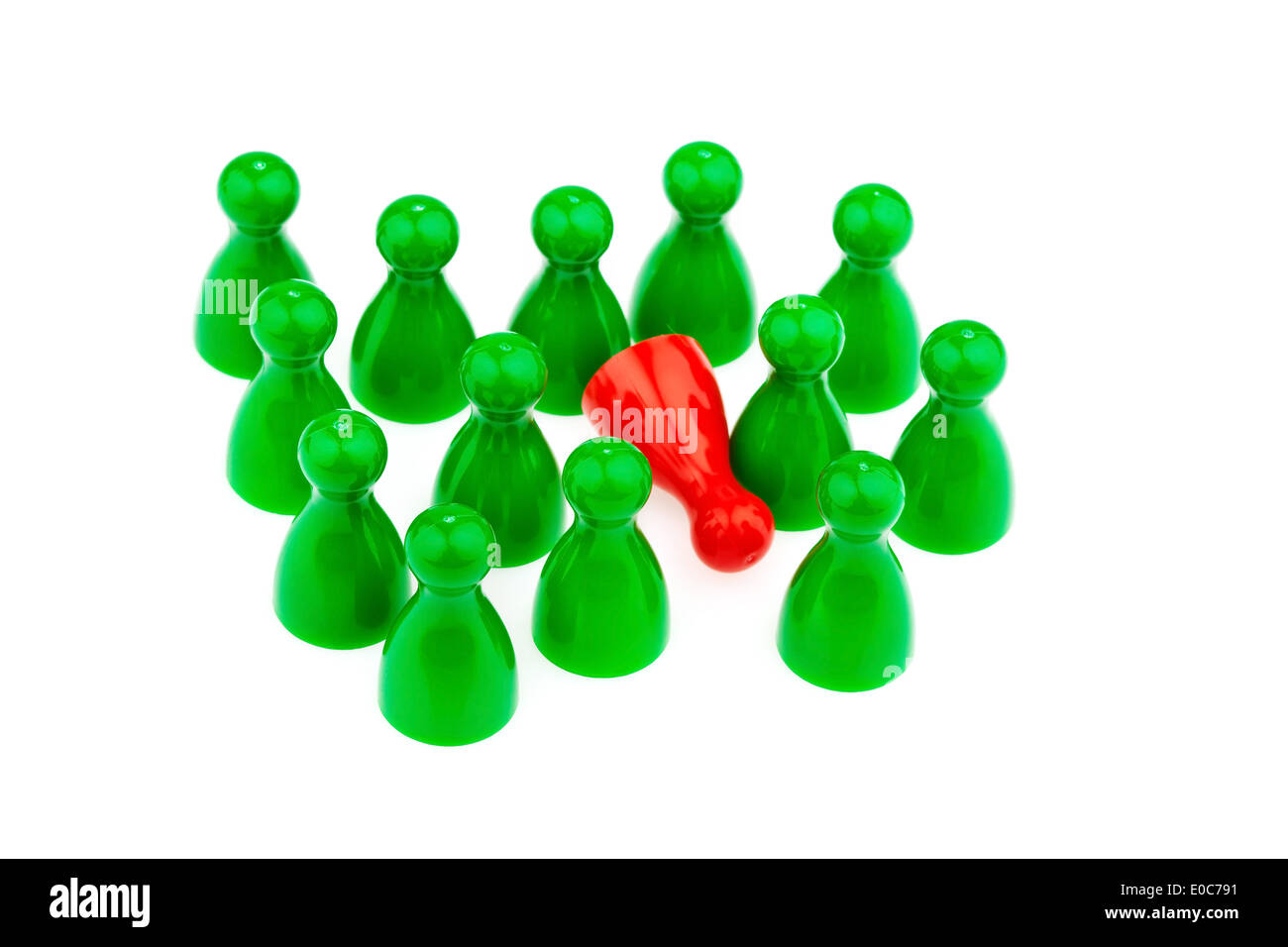 Red and green play figures. Harassment, loneliness and outsider in the team., Rote und gruene Spielfiguren. Mobbing, Einsamkeit Stock Photo