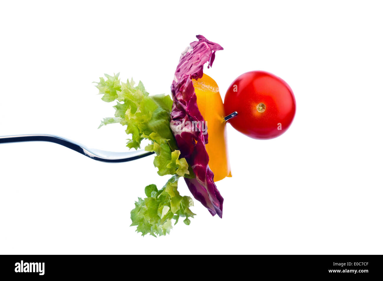 Salad and vegetables on a fork. Healthy food with biological food, Salat und Gemuese auf einer Gabel. Gesunde Ernaehrung mit b Stock Photo