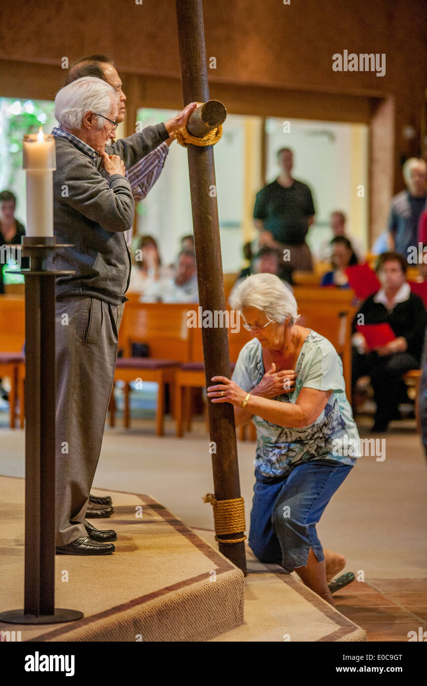 During the Good Friday mass at St. Timothy's Catholic Church, Laguna Niguel, CA, parishioners participate in the Solemn Veneration of the Cross. Stock Photo