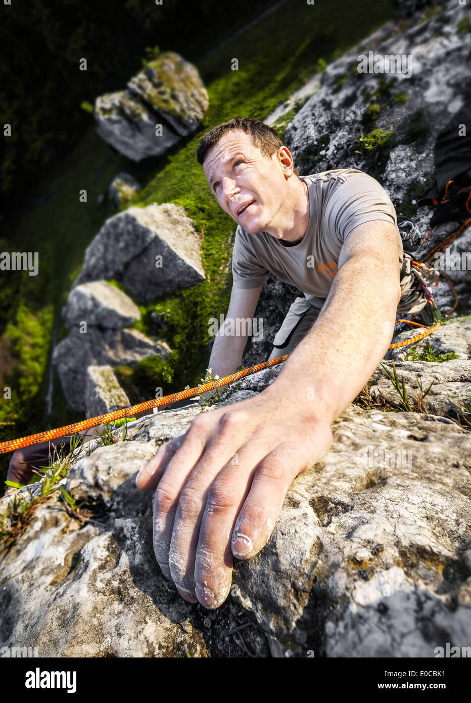 Man climbing natural rocky wall. Stock Photo