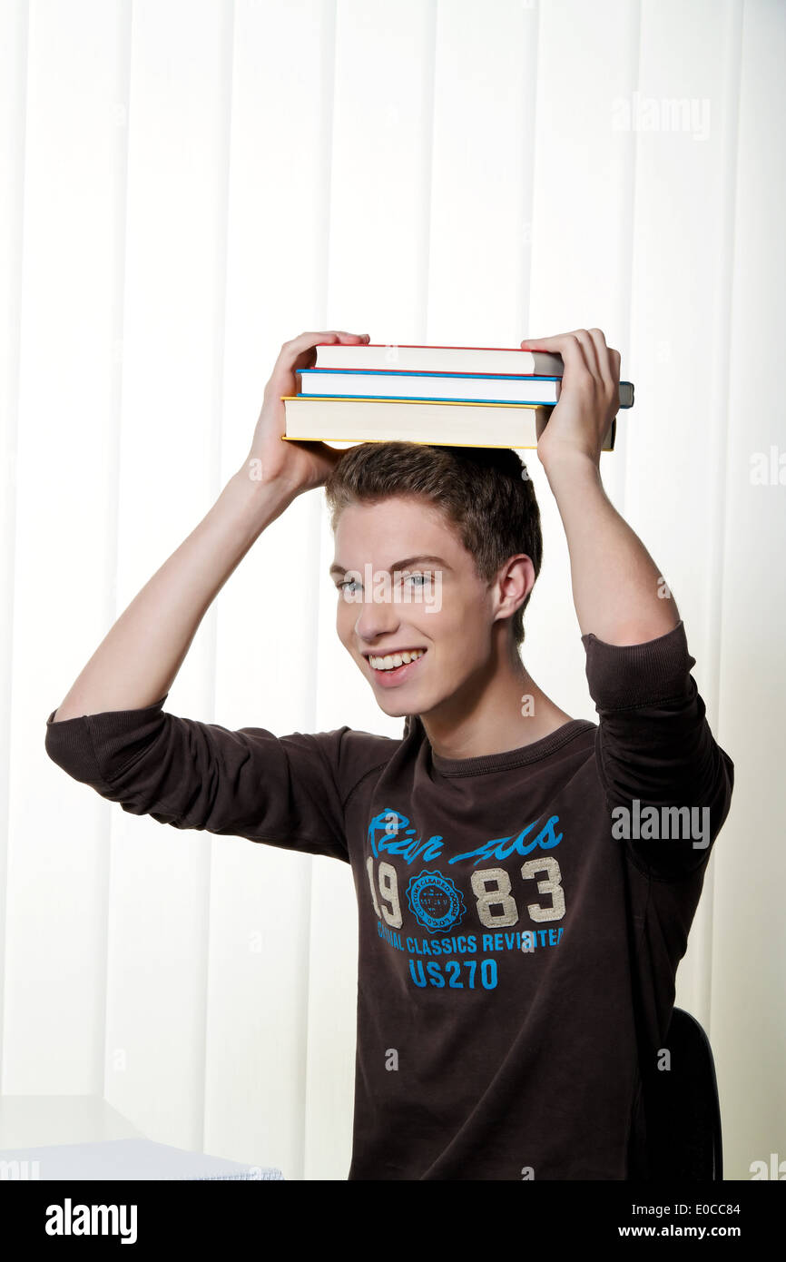 A young student with learn with books, Ein junger Student beim lernen mit Buechern Stock Photo