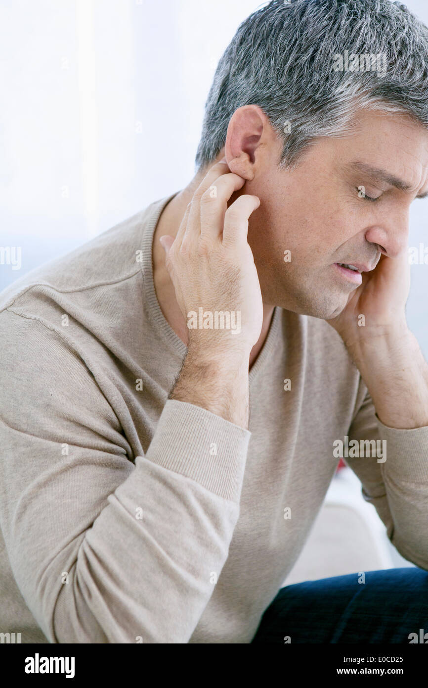 Ear pain in a man Stock Photo