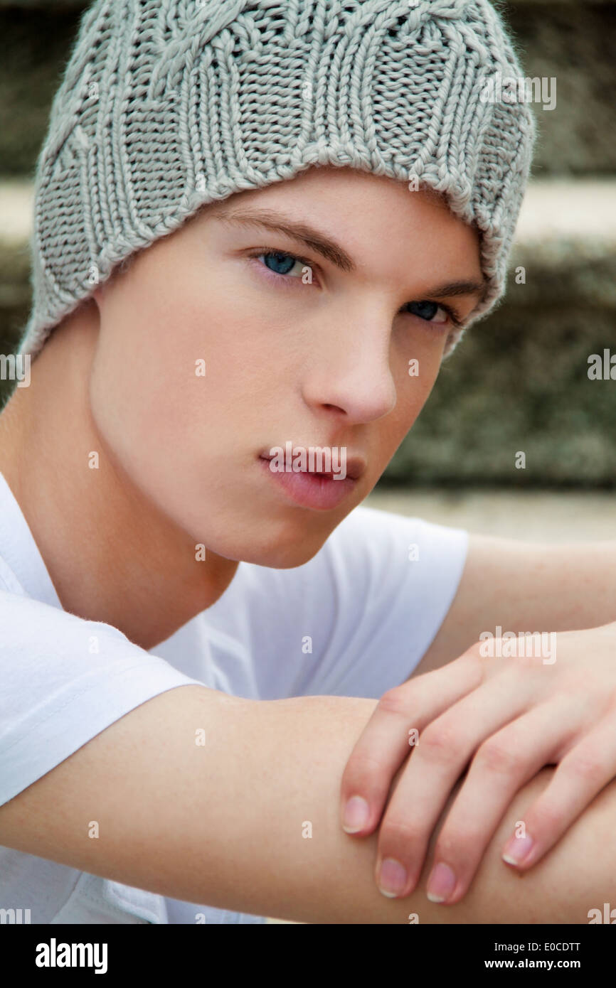 A cool looking youthful man with bonnet, Ein cool blickender Jugendlicher Mann mit Haube Stock Photo