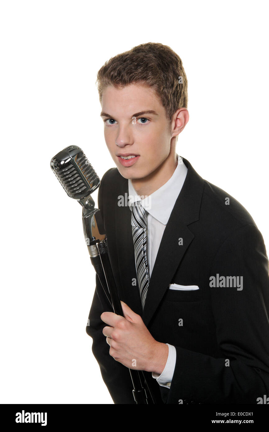 A young singer with Retro microphone sings karaoke, Ein junger Saenger mit Retro Mikrofon singt Karaoke Stock Photo