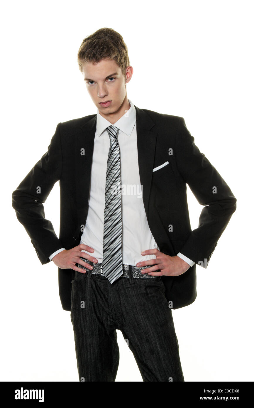 A sceptical young man in the studio. Dressed with a suit, Ein skeptischer junger Mann im Studio. Bekleidet mit einem Anzug Stock Photo