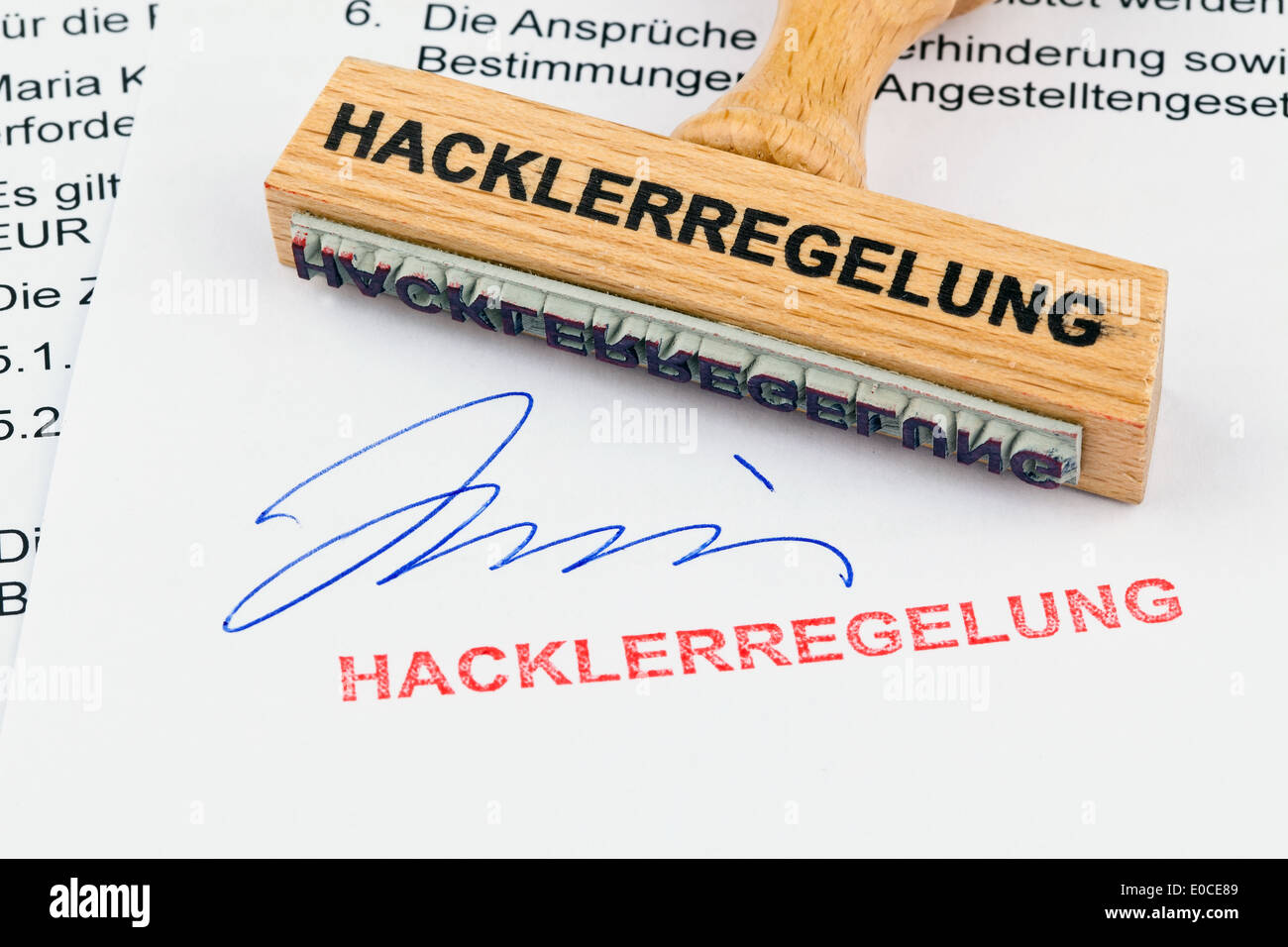 A stamp of wood lies on a document. Label Hacklerregelung, Ein Stempel aus Holz liegt auf einem Dokument. Aufschrift Hacklerrege Stock Photo