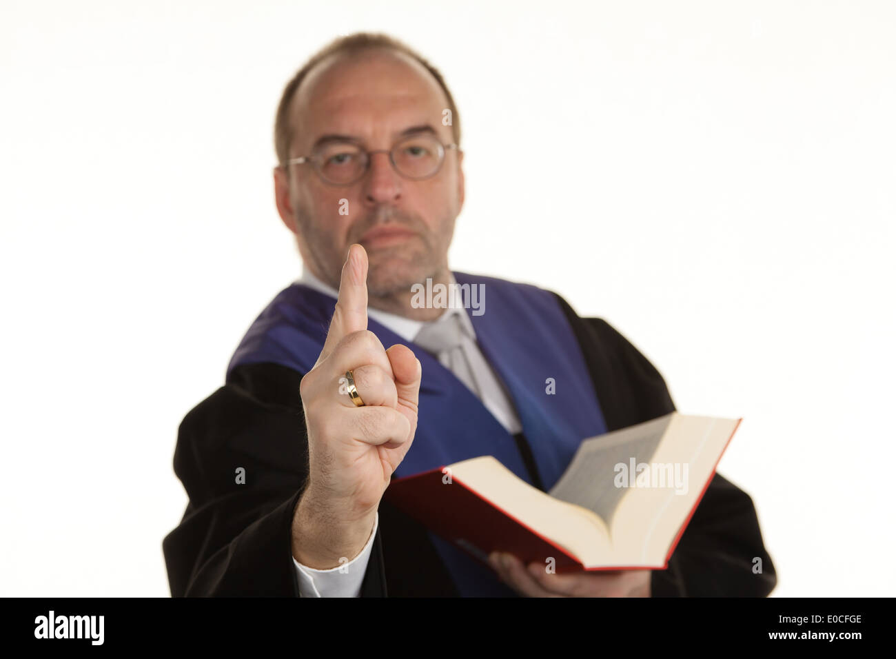 A judge with a code at court. Gavel in the hand., Ein Richter mit einem Gesetzbuch bei Gericht. Gavel in der Hand. Stock Photo