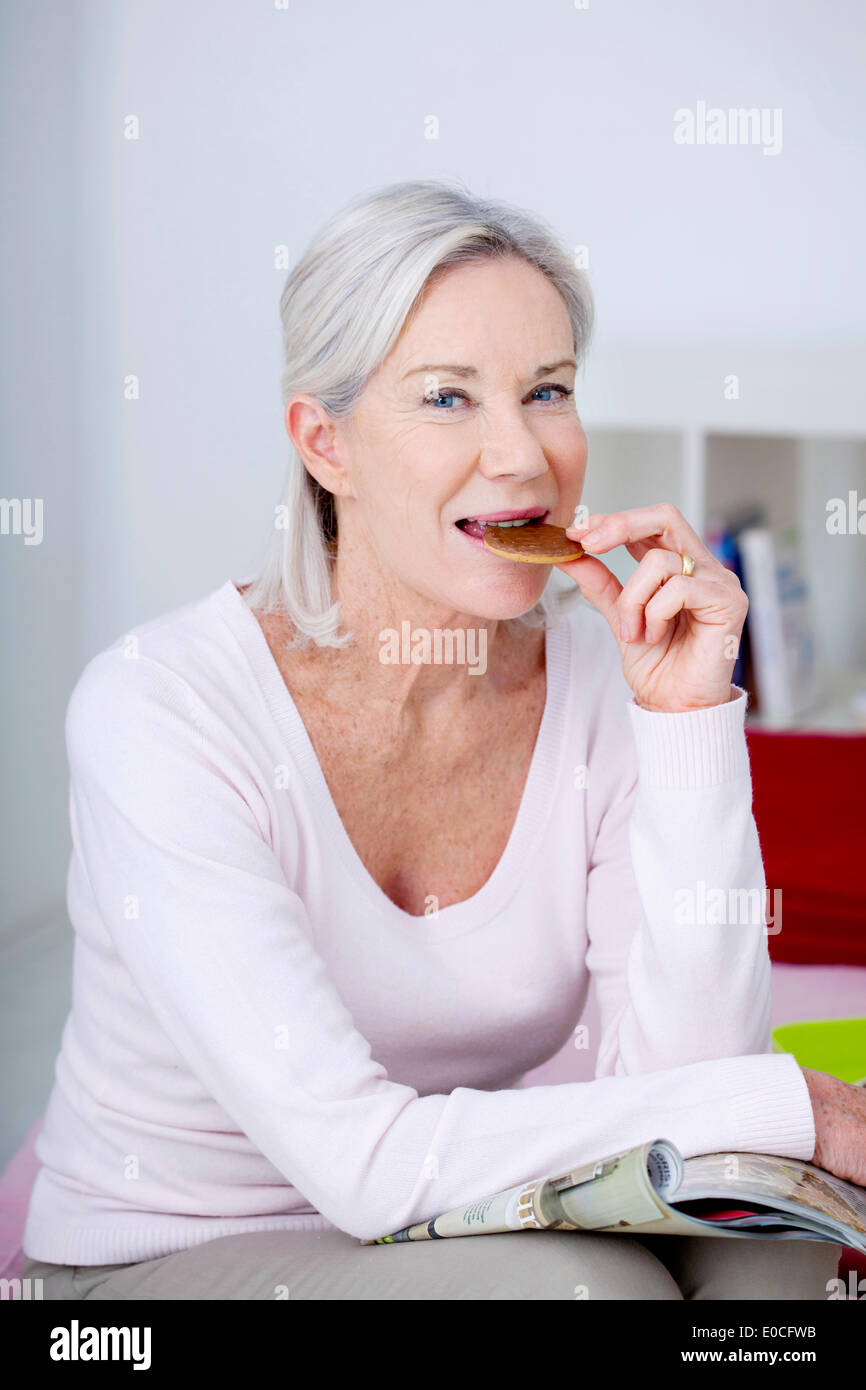 Elderly person eating sweets Stock Photo Alamy