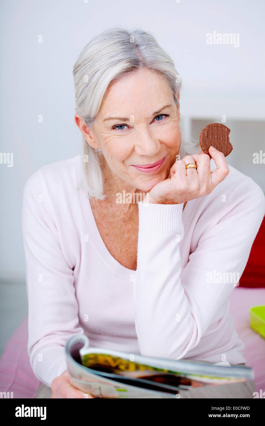 Elderly person eating sweets Stock Photo Alamy