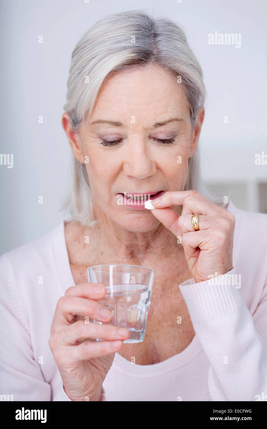 Elderly person taking medication Stock Photo Alamy