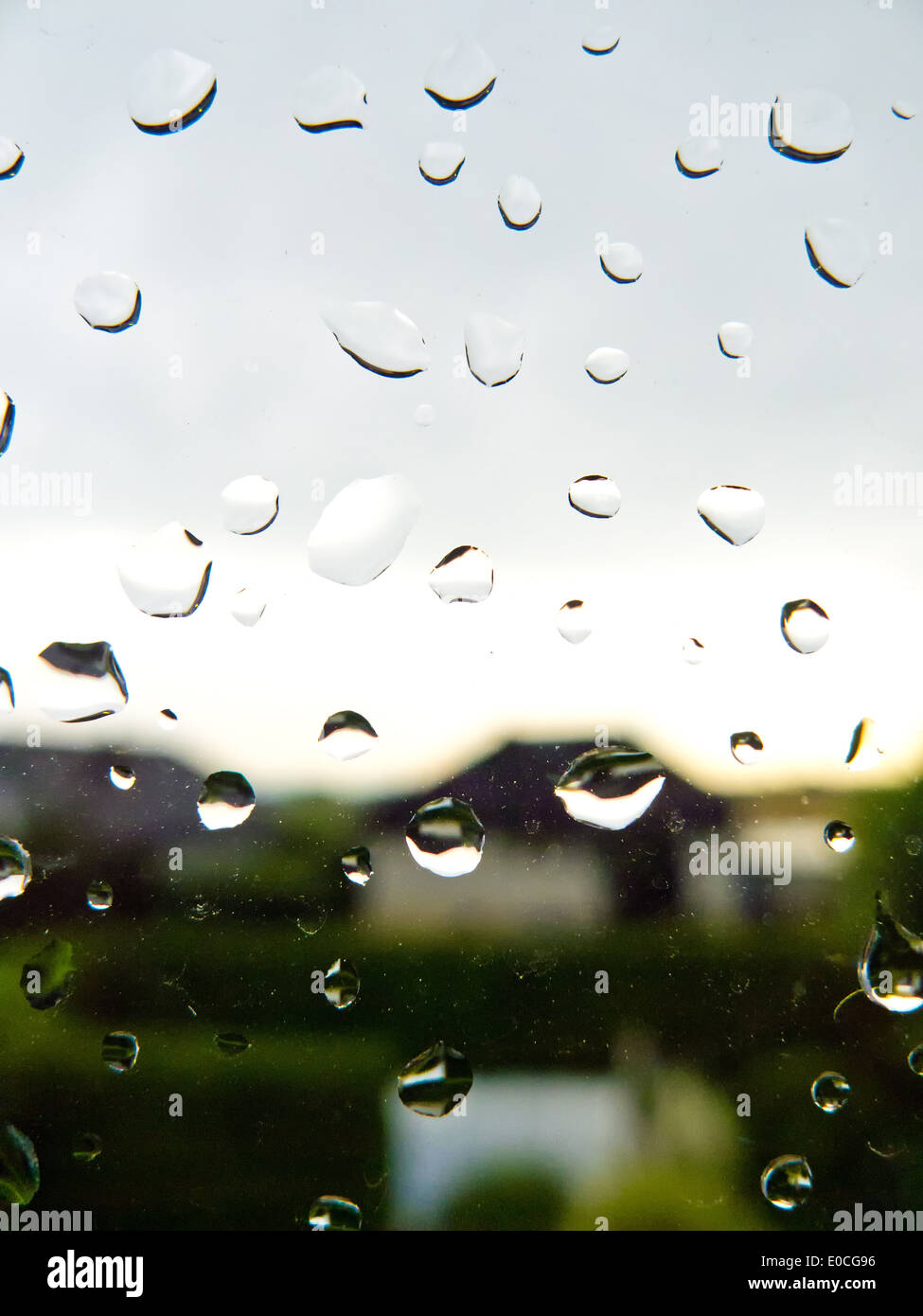 Raindrops drops disc window windowpane glass window drop of water water nature weather rain rain weather bad bad weather rainy d Stock Photo