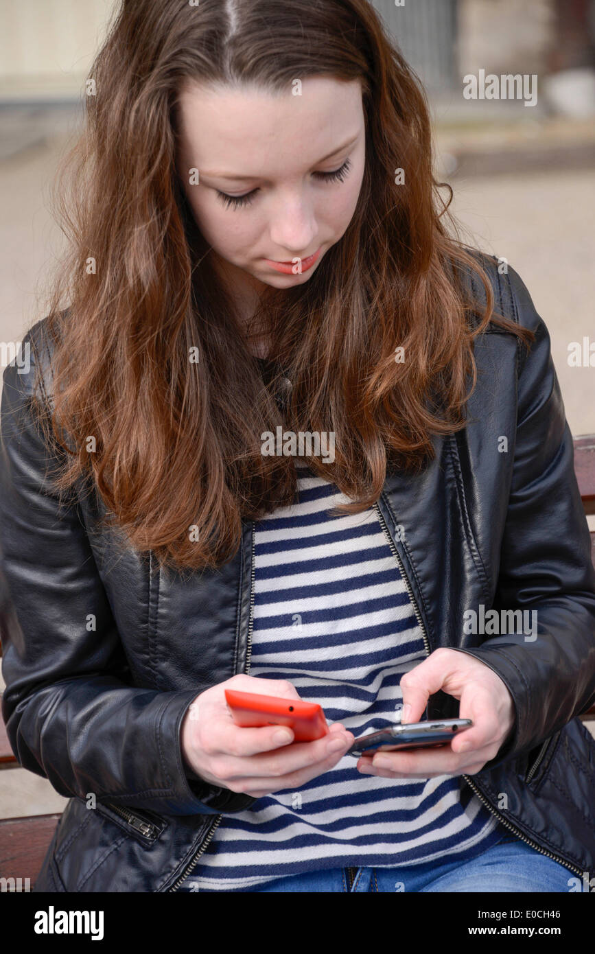 Adolescent with phone Stock Photo