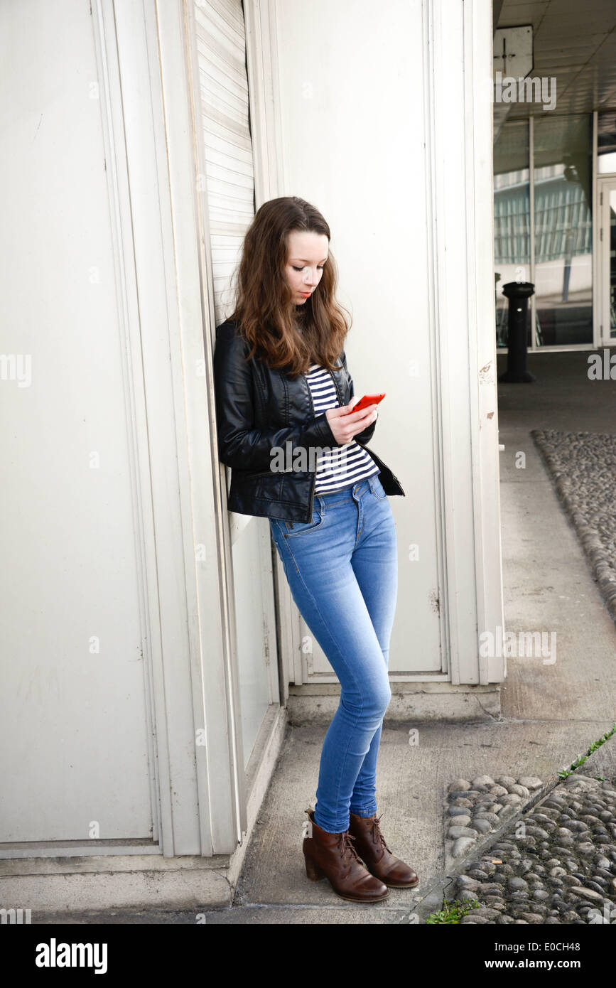 Adolescent with phone Stock Photo