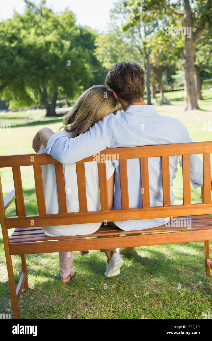 Couple relaxing on park bench together Stock Photo - Alamy