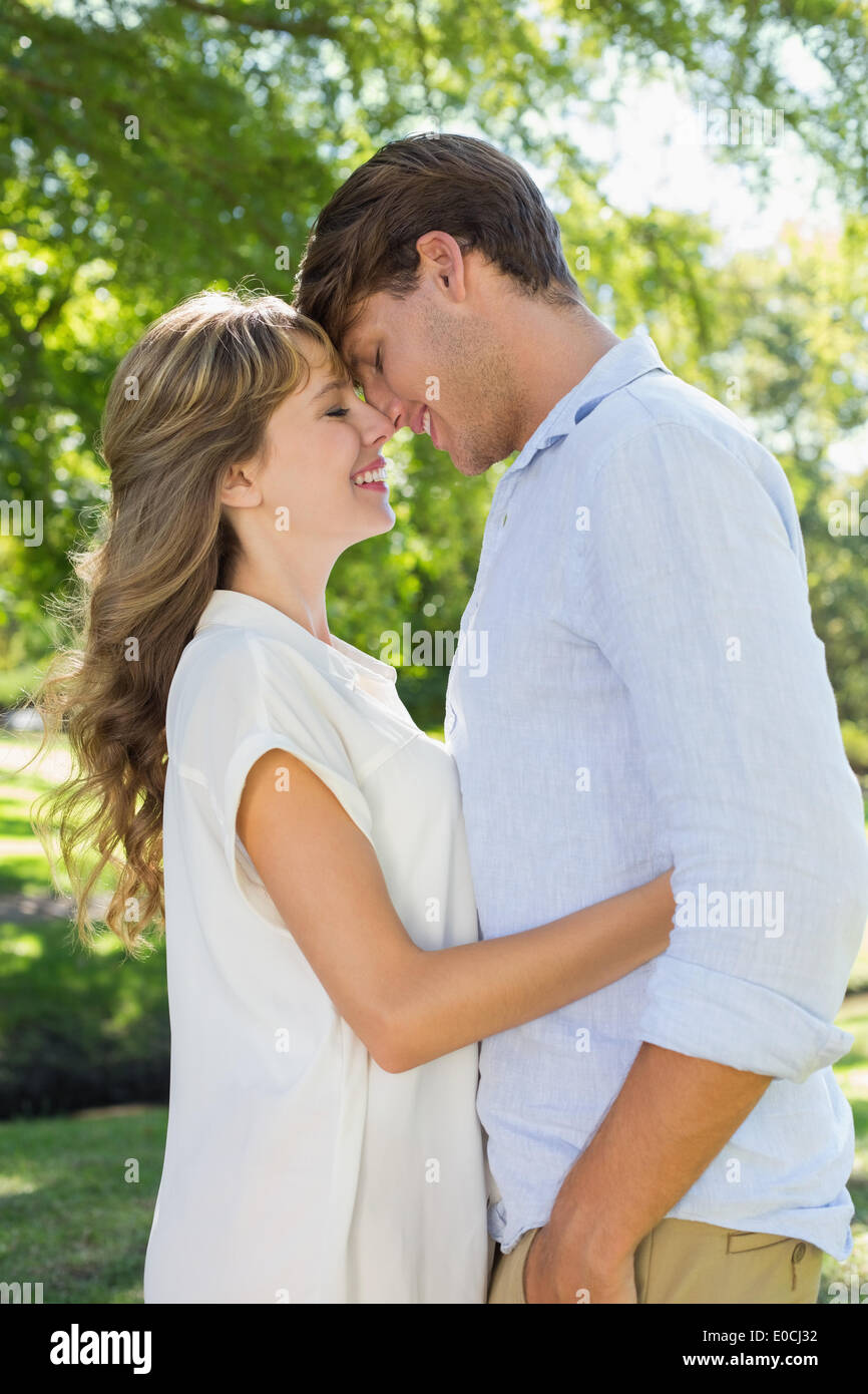 Cute couple hugging and smiling in the park Stock Photo - Alamy