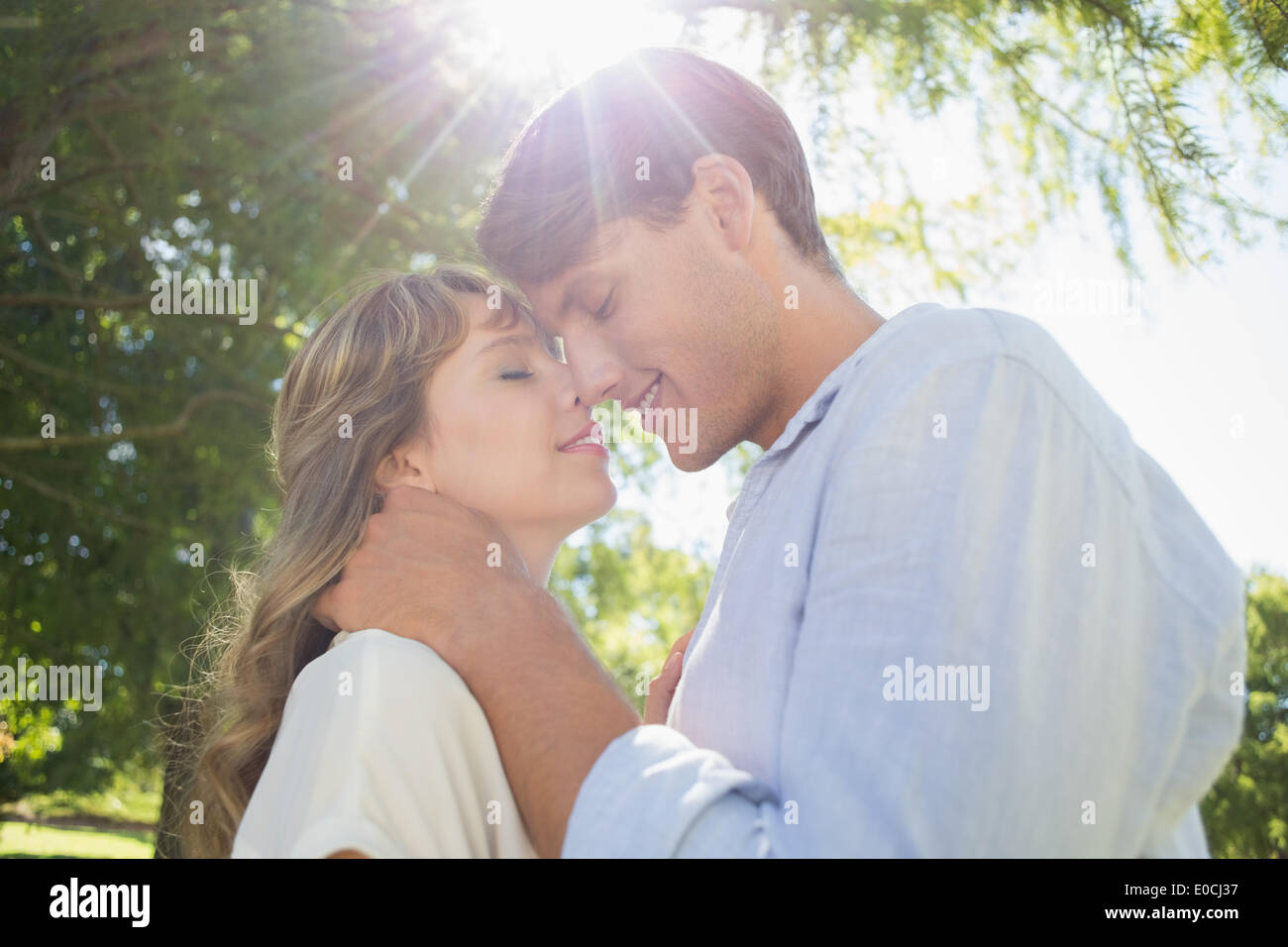 Cute couple hugging and smiling in the park Stock Photo - Alamy