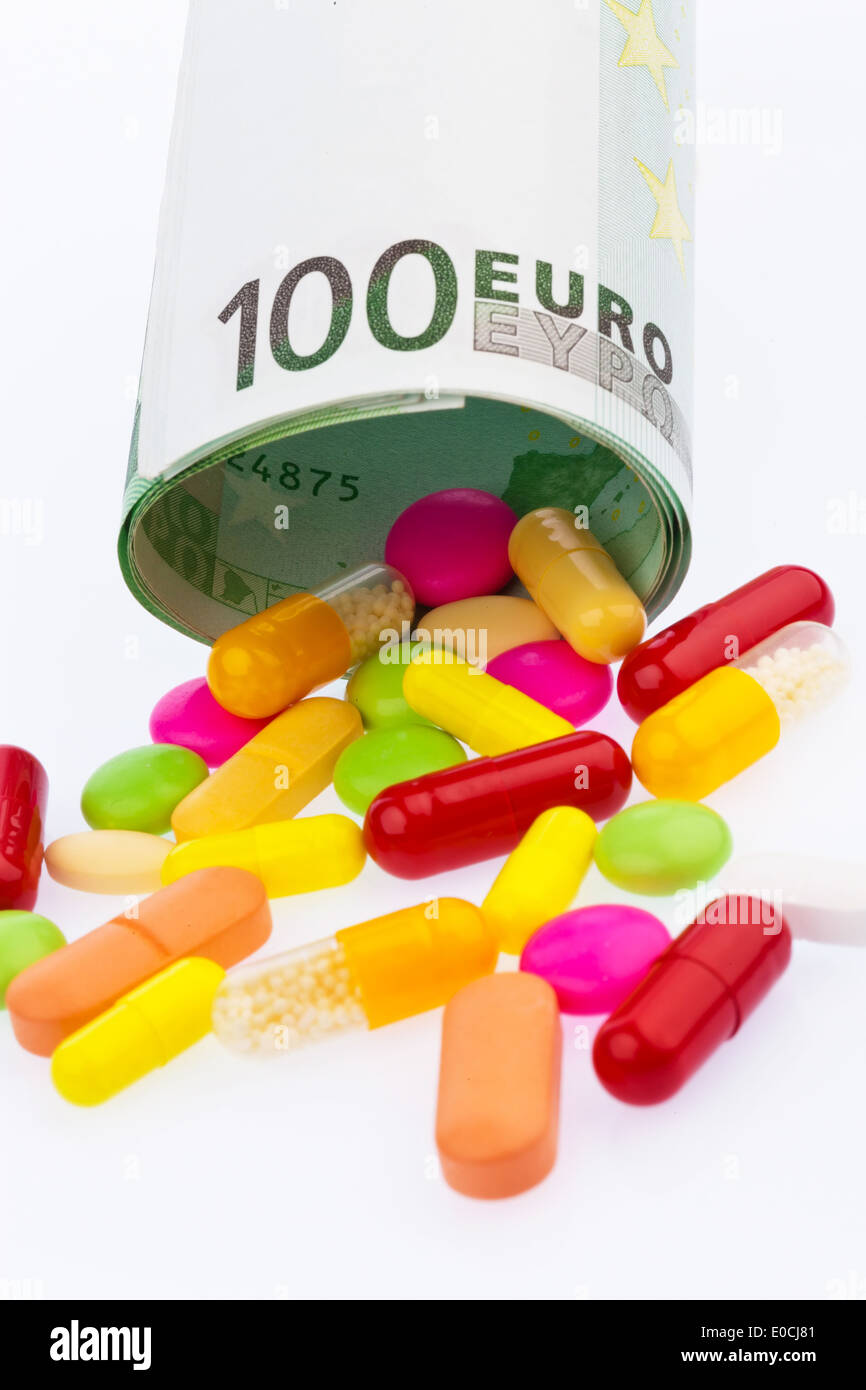 100 euronotes and tablets on wei? ?? to em background., Ein 100 Euroschein und Tabletten auf weiﬂem Hintergrund. Stock Photo