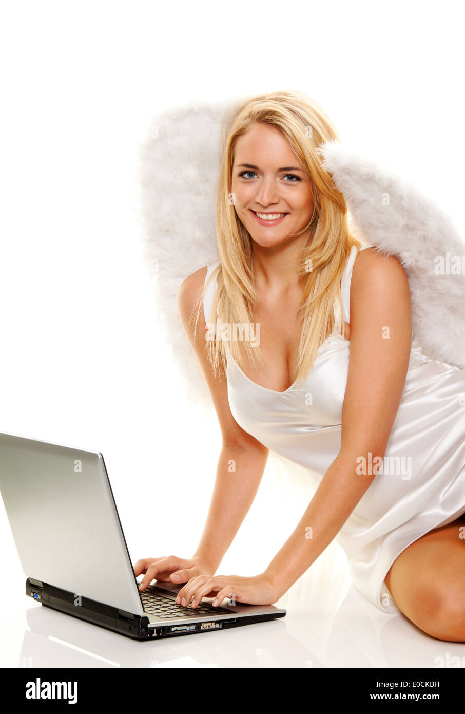 Blond angel at Christmas accepts wishes with laptop., Blonder Engel zu Weihnachten nimmt Waeuensche mit Laptop an. Stock Photo