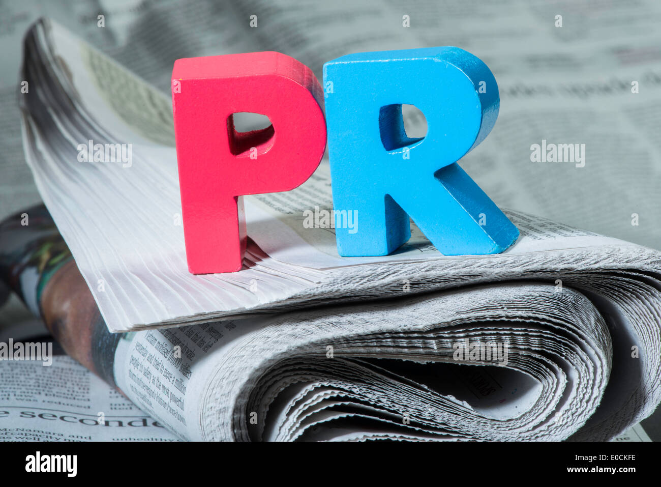 Word PR on newspaper. Wooden letters Stock Photo