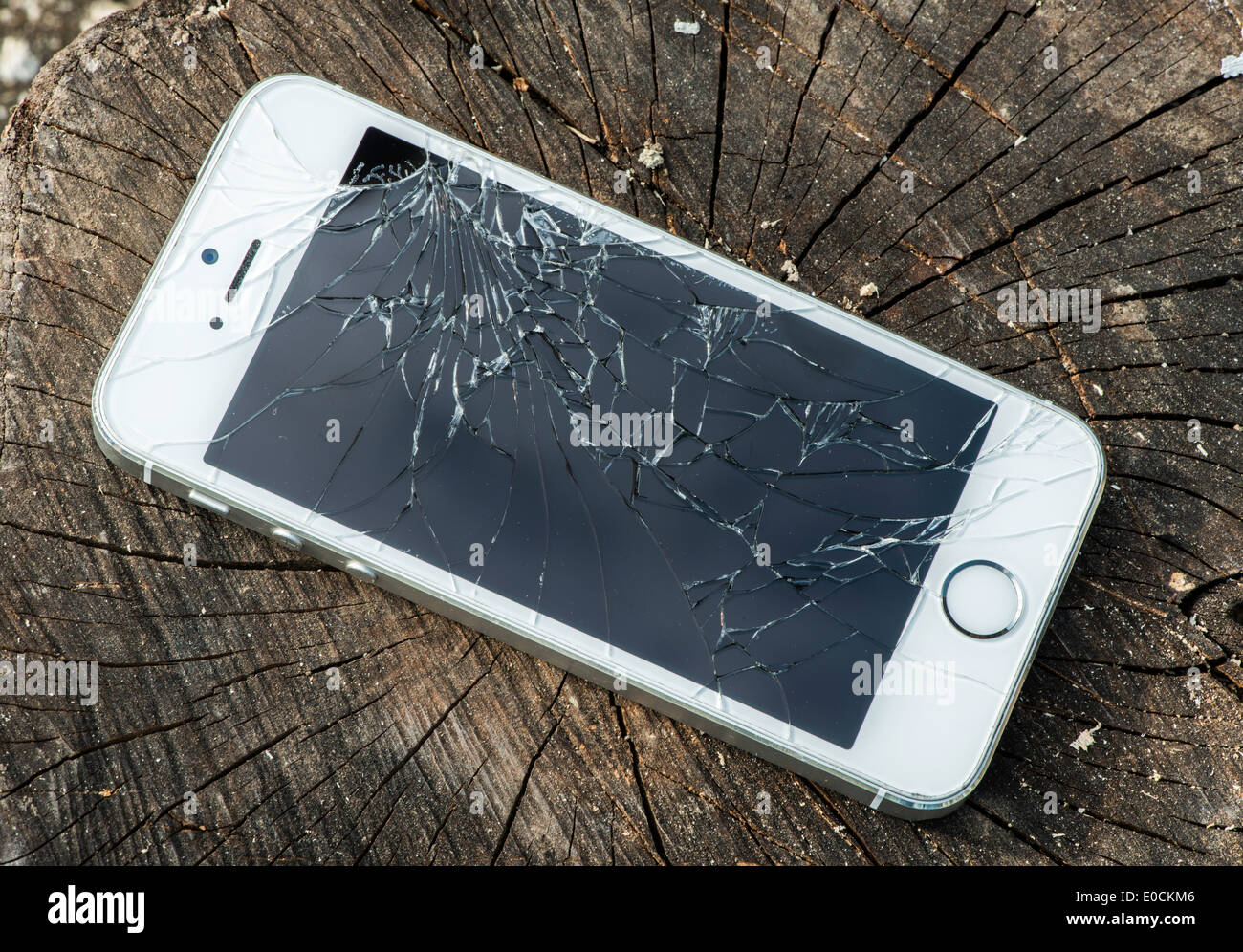 Broken white iphone glass on wood Stock Photo