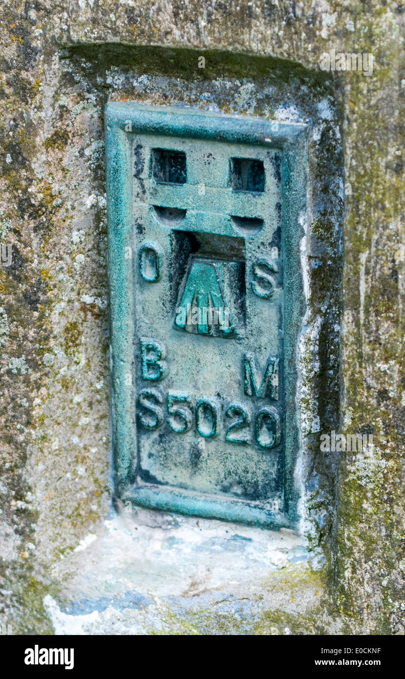 The benchmark on the side of a triangulation station or trig point on a hill top Stock Photo