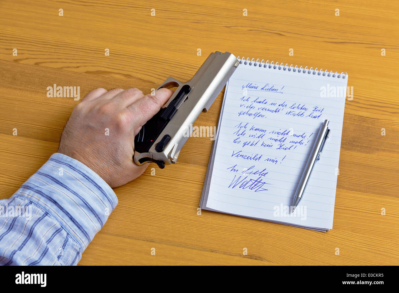 A resignation letter and the gun of a selfmurderer., Ein Abschieds Brief und die Pistole eines Selbstmoerders. Stock Photo