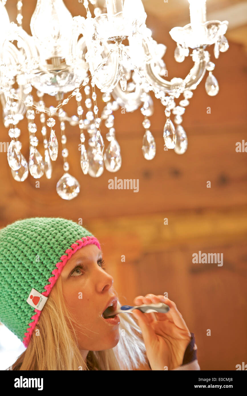 Young woman brushing her teeth, See, Tyrol, Austria Stock Photo