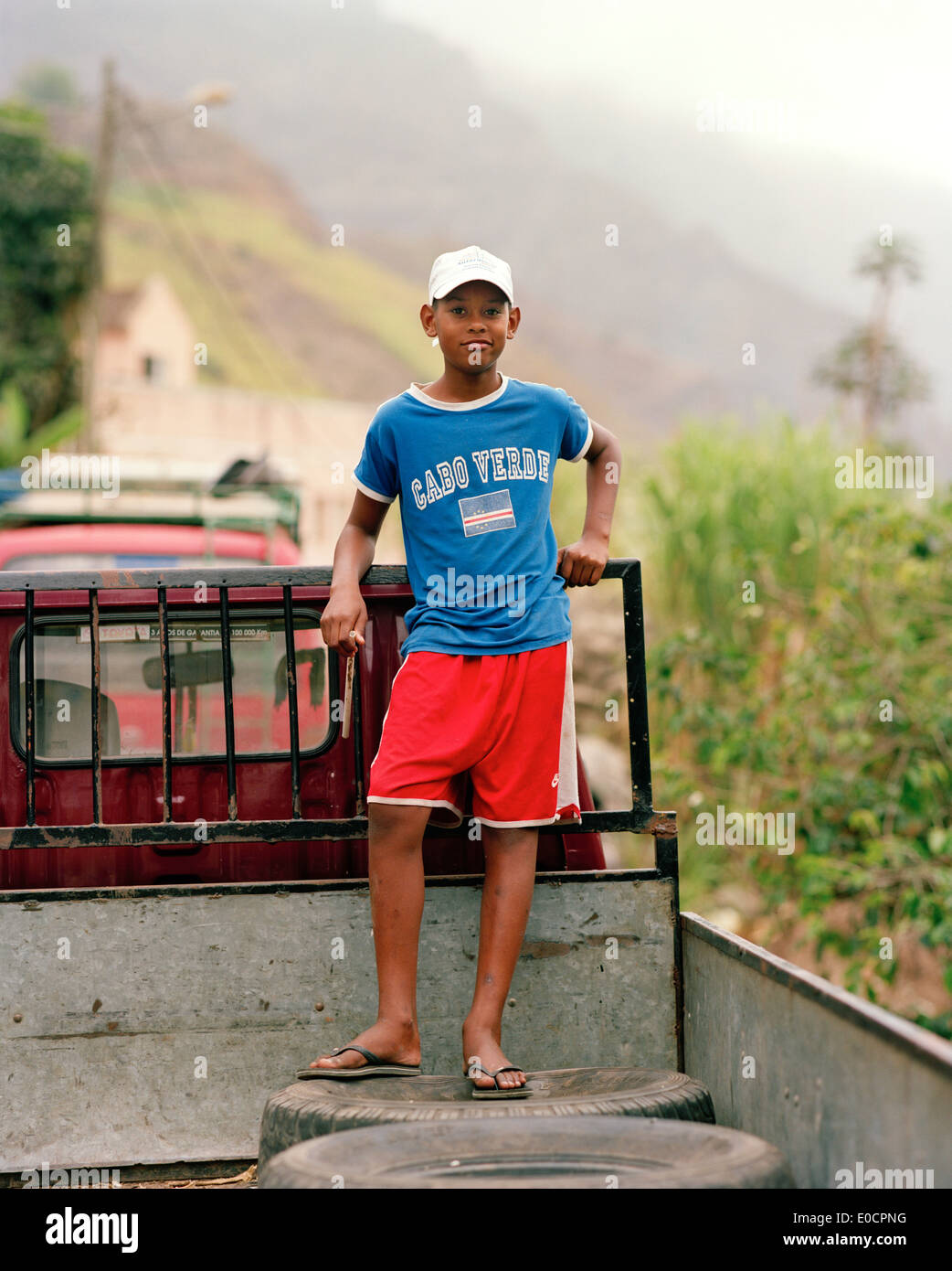 Boy on the bed of a pickup at the village Cha Manuel Dos Santos